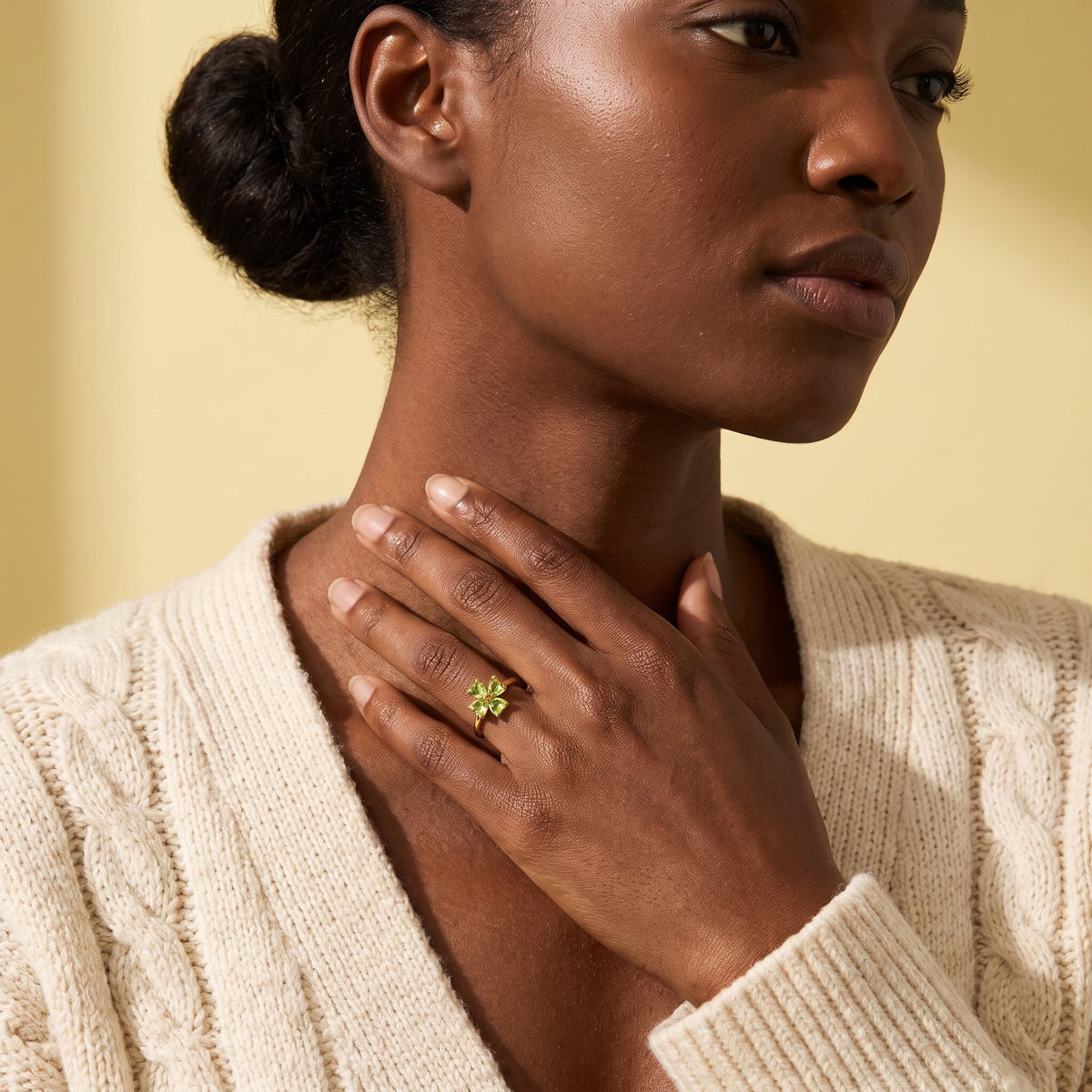 Model wearing a peridot four leaf clover ring