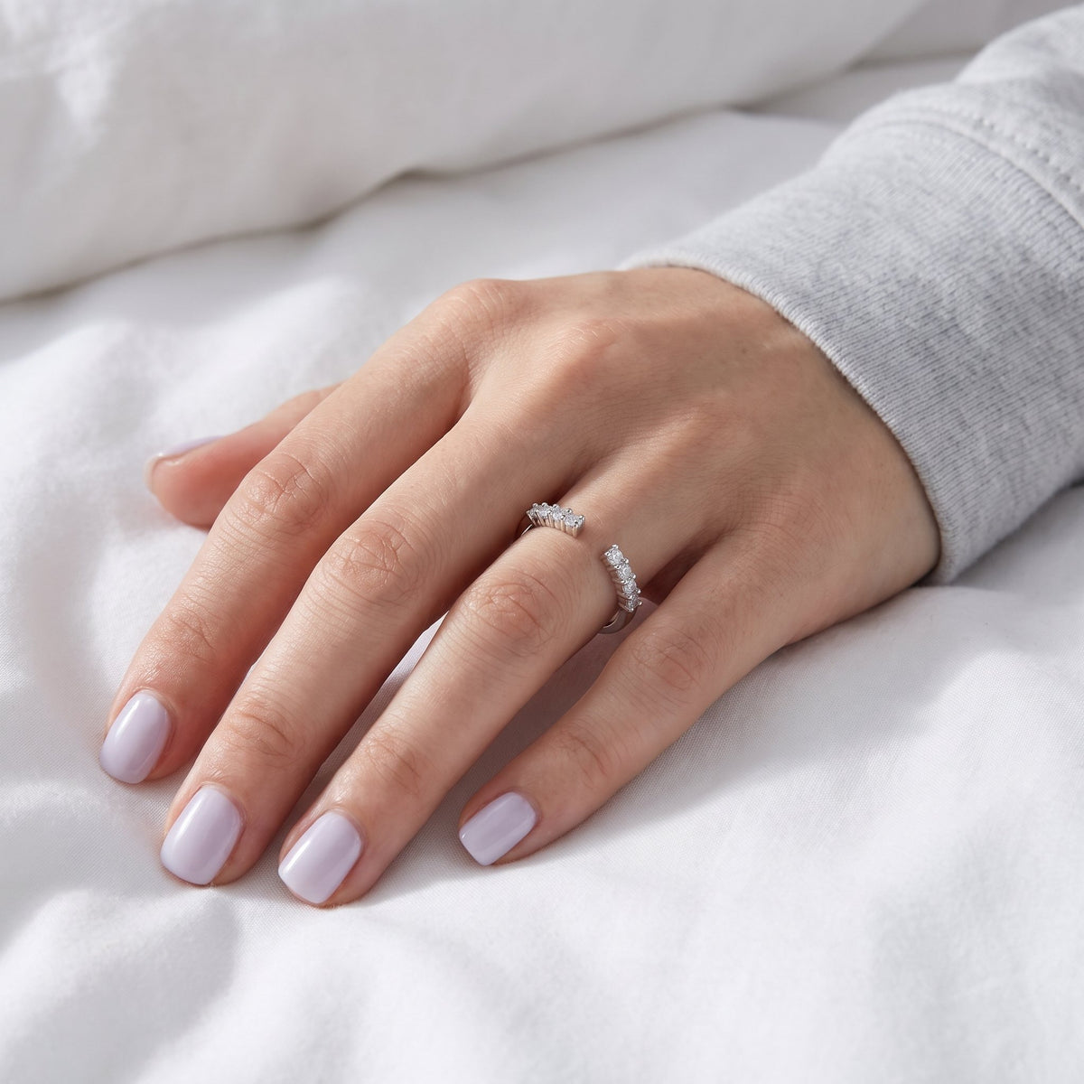 Hand on white linen wearing a sparkle band ring
