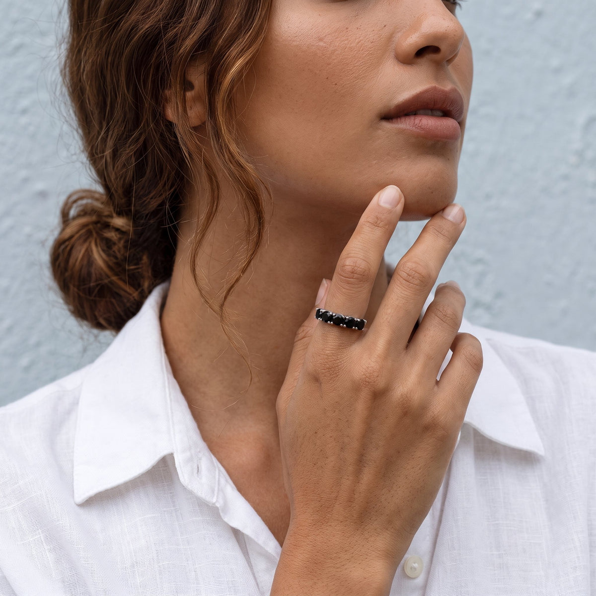Model wearing a black obsidian five stone ring