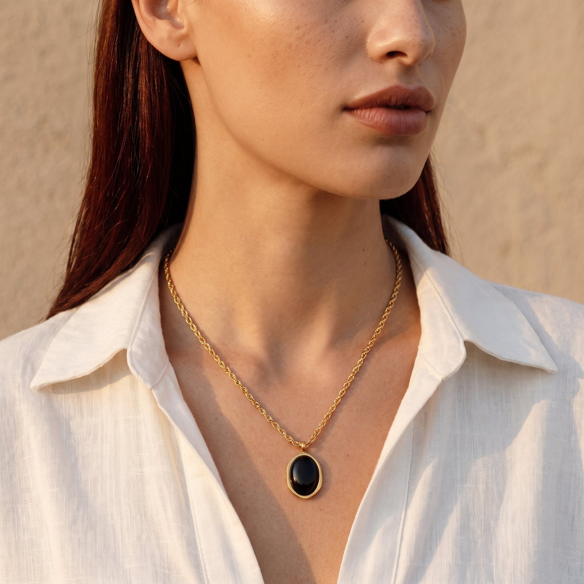 Model wearing a black obsidian oval pendant necklace